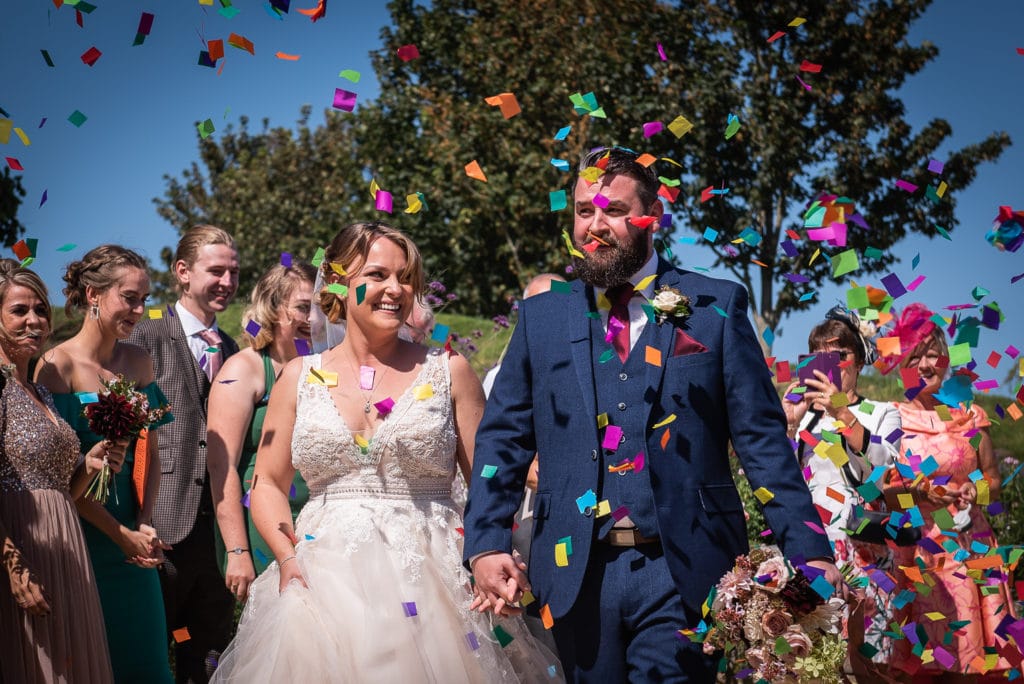 colourful confetti with bride and groom 