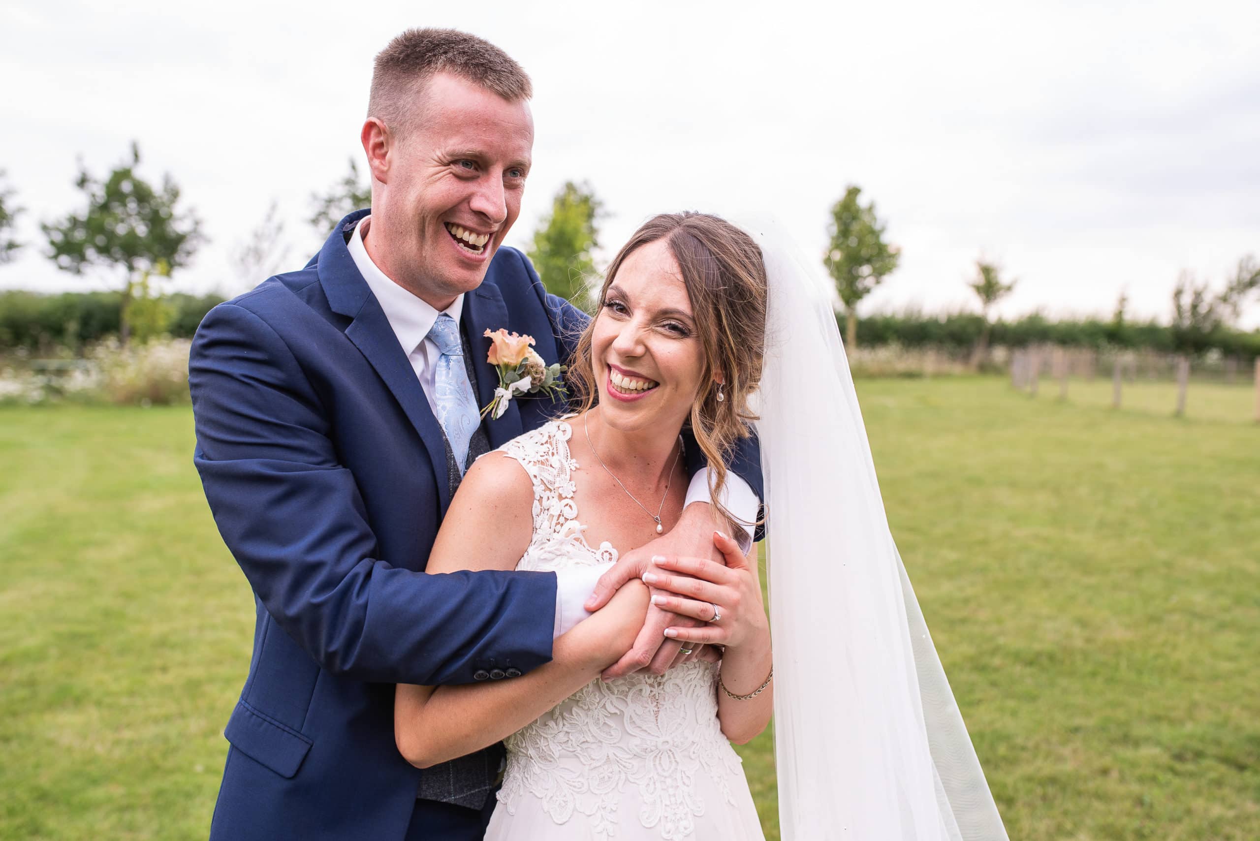 couple laughing during portraits at South Farm Hertfordshire.